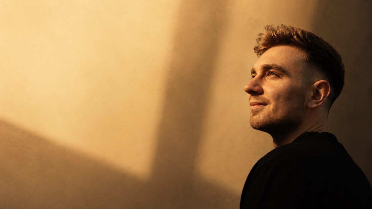 Warm side portrait of Patryk Kozieł